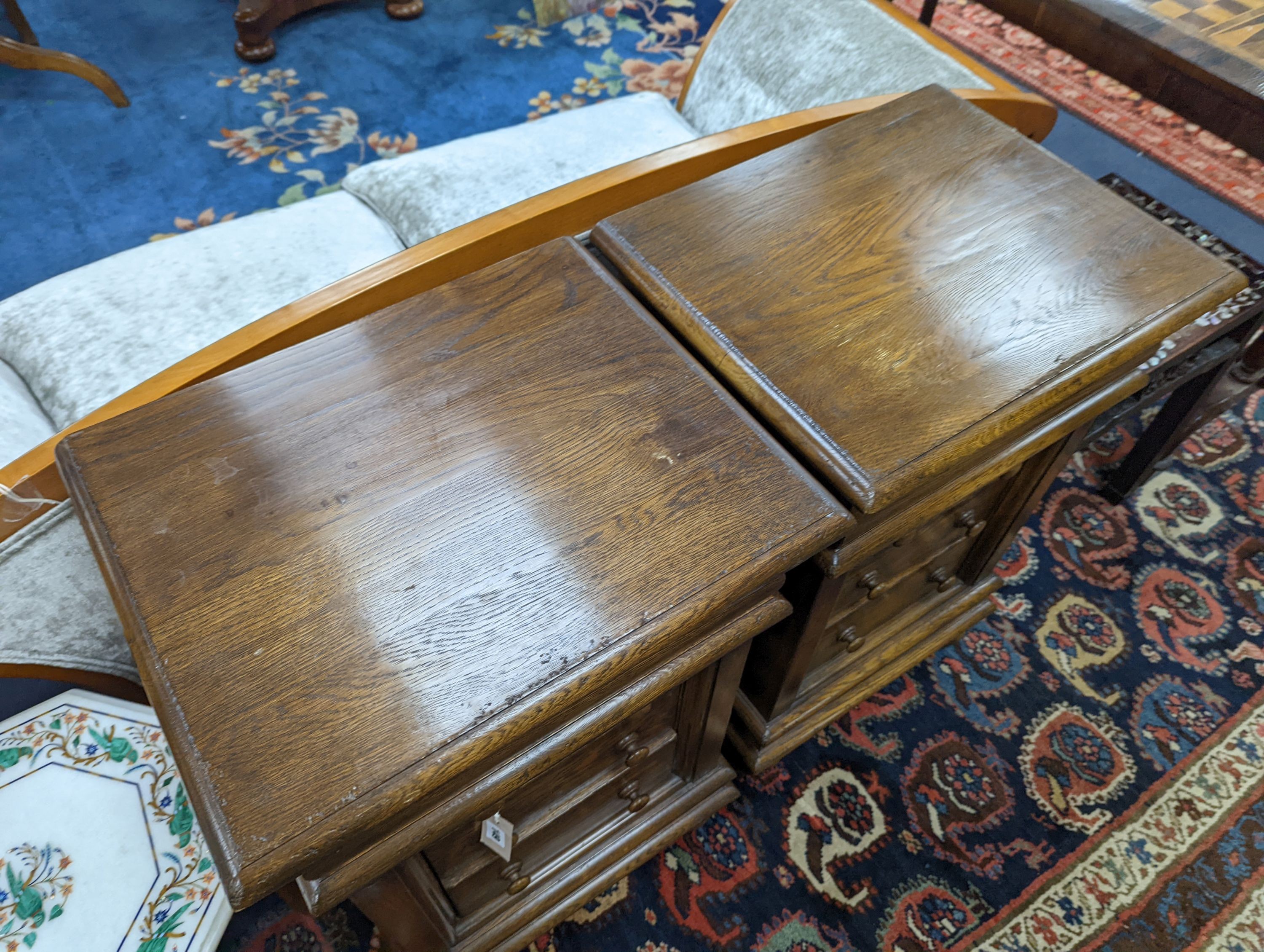 A pair of reproduction oak four drawer bedside chests, width 51cm, depth 41cm, height 79cm